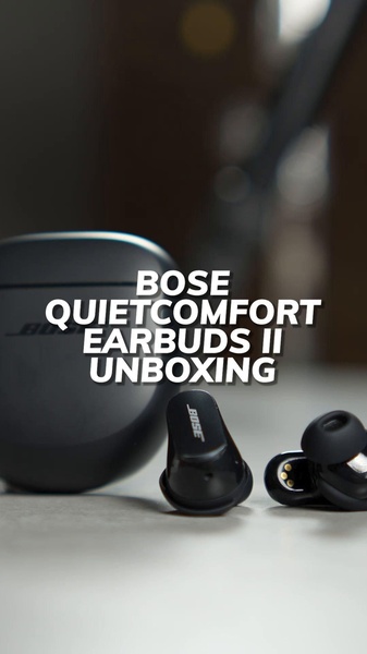 A clean, studio-lit unboxing shot featuring premium earbuds and their charging case, using bold center-aligned text to identify the product.