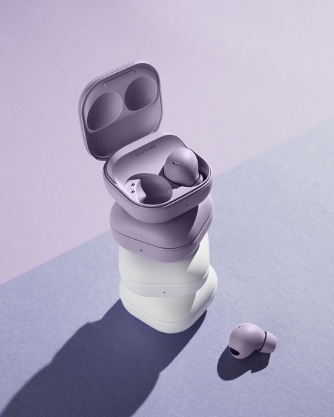 A clean, high-contrast studio shot featuring stacked wireless earbud cases in varying colors, using a balanced vertical composition to highlight product design.