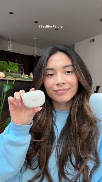 A close-up, authentic influencer-style video ad featuring a pair of earbuds in a modern, home-inspired setting.
