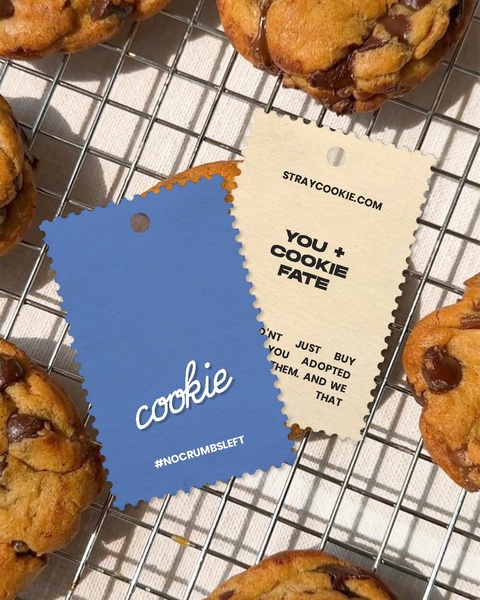 This creative uses physical product tags placed directly on a wire cooling rack of freshly baked chocolate chip cookies to create an authentic, artisanal feel.