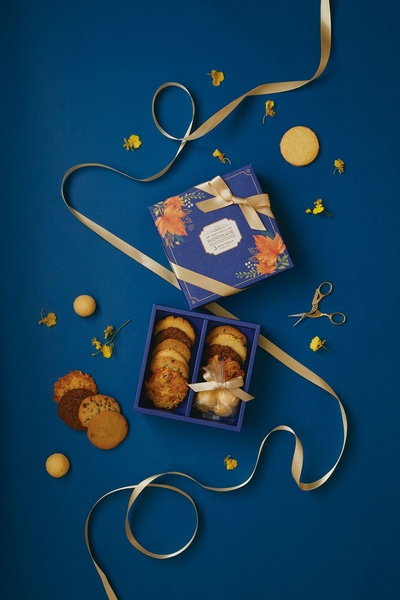 assorted cookies, cookie gift box, gourmet cookies, bakery gift set, baked cookies, gift guide, flat lay, minimalist, calm, luxurious, blue, gold, neutral