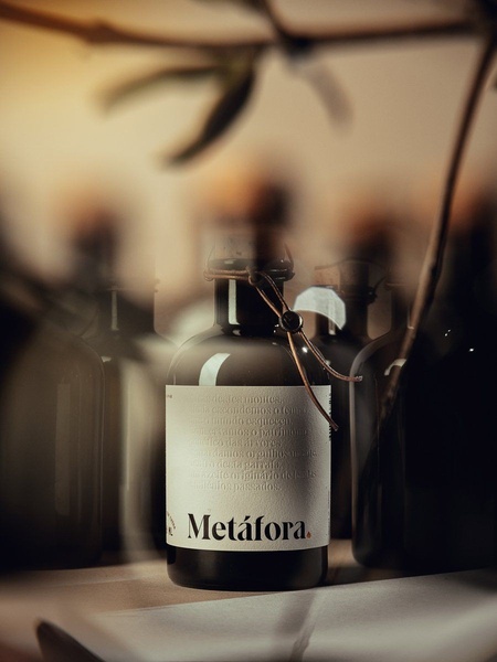A high-end, atmospheric product shot of an olive oil bottle, featuring intentional bokeh, soft natural lighting, and a storytelling label.