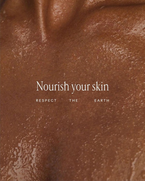A close-up, high-texture shot of skincare product being applied to skin, focusing on natural nourishment and ethical values.