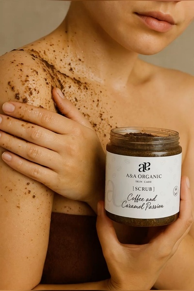 This creative features a close-up, high-texture shot of a model applying a coffee-based scrub to their shoulder while holding the product jar.