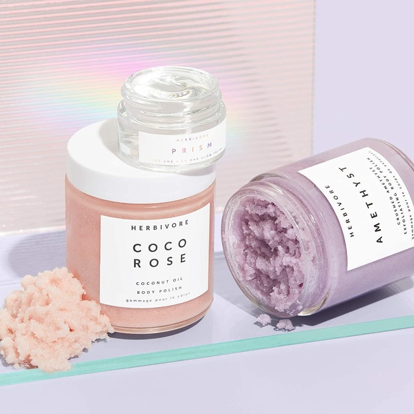 A clean, studio-lit aesthetic showing three distinct skincare products arranged on a lavender background with raw product texture visible.