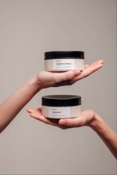 A split-view image showing two sets of hands holding different variants of body butter in a clean, neutral studio setting.