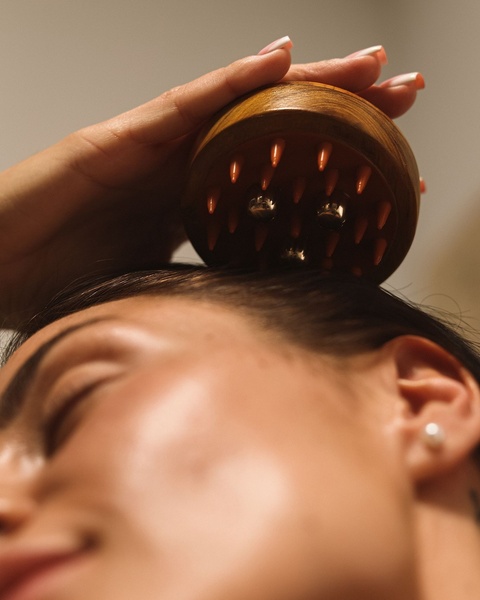 A close-up, high-quality image showing a scalp massager in use, emphasizing the tactile, relaxing experience of the product.